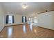 Spacious living room with wood floors, large windows, and a ceiling fan at 546 Treyburn Lakes Way, Indianapolis, IN 46239