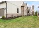 Home exterior features a well manicured lawn, brick trim, and decorative chimney at 583 Exmoor Dr, Carmel, IN 46032