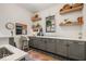 Stylish laundry room with ample counter space, custom cabinets, and modern black and white flooring at 583 Exmoor Dr, Carmel, IN 46032