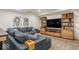 Inviting basement living room with a large sectional, custom built-ins, and stylish decor at 583 Exmoor Dr, Carmel, IN 46032