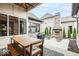 Outdoor patio with a fireplace, seating area, dining table, and professionally landscaped backyard at 583 Exmoor Dr, Carmel, IN 46032