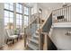 Elegant staircase with large windows, providing plenty of natural light to the home's entrance at 583 Exmoor Dr, Carmel, IN 46032