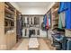 Spacious walk-in closet featuring custom wood shelving, hanging racks, and a stylish bench at 583 Exmoor Dr, Carmel, IN 46032