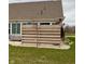 Backyard featuring a wooden fence, stone pathway, and manicured grass at 5875 Mill Haven Way, Noblesville, IN 46062