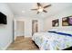 Bedroom with floral bedding, TV and modern ceiling fan at 5875 Mill Haven Way, Noblesville, IN 46062