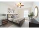 Comfortable bedroom features decorative pictures, a ceiling fan, and ample lighting at 5875 Mill Haven Way, Noblesville, IN 46062