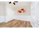 Bedroom featuring decorative wainscoting, modern art, and a ceiling fan at 5875 Mill Haven Way, Noblesville, IN 46062