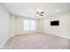 Spacious bonus room has neutral carpet, a ceiling fan, and a television on the wall at 5875 Mill Haven Way, Noblesville, IN 46062