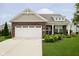 Charming single-Gathering home with red brick, a white garage door, and well-manicured landscaping at 5875 Mill Haven Way, Noblesville, IN 46062