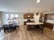 Open kitchen with an island, stainless steel appliances, and a dining area, creating a perfect cooking and dining space at 5875 Mill Haven Way, Noblesville, IN 46062