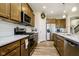 A well-equipped kitchen features stainless steel appliances, granite countertops, and wood-look flooring at 5875 Mill Haven Way, Noblesville, IN 46062