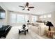 Open-concept living room with large windows, ceiling fan, and view into dining area at 5875 Mill Haven Way, Noblesville, IN 46062