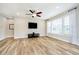 Living room features many windows allowing ample natural light and modern ceiling fan at 5875 Mill Haven Way, Noblesville, IN 46062