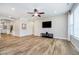 Living room features many windows allowing ample natural light, TV, and modern ceiling fan at 5875 Mill Haven Way, Noblesville, IN 46062