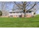 A charming home nestled in a lush lawn, featuring a stone retaining wall, offering both beauty and privacy at 5913 W Maple Dr, Frankton, IN 46044