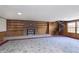 Finished basement featuring a fireplace, built-in shelves, and a spiral staircase at 5913 W Maple Dr, Frankton, IN 46044