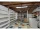 The basement offers a laundry area and potential storage solutions with exposed beams at 5913 W Maple Dr, Frankton, IN 46044