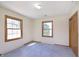This bright bedroom features two windows, neutral walls, and carpet flooring at 5913 W Maple Dr, Frankton, IN 46044