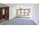 Bright dining room with large windows and neutral decor is perfect for Gathering meals at 5913 W Maple Dr, Frankton, IN 46044
