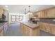 Bright kitchen features an island and a spacious dining area with large windows at 5913 W Maple Dr, Frankton, IN 46044