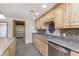 This kitchen features stainless steel appliances, granite countertops, and light wood cabinets at 5913 W Maple Dr, Frankton, IN 46044