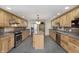 Open kitchen showcases a center island, stainless steel appliances, and ample counter space at 5913 W Maple Dr, Frankton, IN 46044