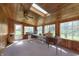 This sunroom is bright with wood paneling, a skylight, and multiple windows at 5913 W Maple Dr, Frankton, IN 46044