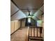 Unique attic space with carpeting, wood trim, and natural light from a single window at 6206 W Us Highway 40, Stilesville, IN 46180