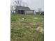The backyard features ample green space, fire pit, and potential for outdoor activities at 6206 W Us Highway 40, Stilesville, IN 46180