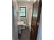 Modest bathroom with updated tile floor, single window, vanity and shower-tub combination at 6206 W Us Highway 40, Stilesville, IN 46180