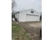 The detached garage offers parking and storage, with a basketball hoop for recreation at 6206 W Us Highway 40, Stilesville, IN 46180