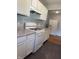 Functional kitchen with stove, refrigerator, light cabinets and countertops with laminate flooring at 6206 W Us Highway 40, Stilesville, IN 46180