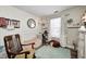 Charming Bedroom with a crib, rocking chair, striped wallpaper, and a comfortable green area rug at 6431 Meadowpond Way, Indianapolis, IN 46235