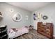 This stylish bedroom features soft green walls, accent decor, vintage dresser, and a warm ambiance at 6431 Meadowpond Way, Indianapolis, IN 46235