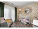 This warm Bedroom includes floral wallpaper, curtains, stylish pendant lighting, and an accent chair at 6431 Meadowpond Way, Indianapolis, IN 46235