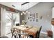 Dining room with wood table, stylish pendant lighting, and sliding glass doors to the backyard at 6431 Meadowpond Way, Indianapolis, IN 46235
