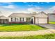 Charming single-story home with a well-manicured lawn, attached garage, and inviting curb appeal at 6431 Meadowpond Way, Indianapolis, IN 46235