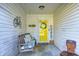 Inviting front porch with a swing, decorations, and a bright yellow door at 6431 Meadowpond Way, Indianapolis, IN 46235