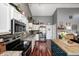 Modern kitchen with stainless steel appliances, wooden floors, and a functional island for meal preparation at 6431 Meadowpond Way, Indianapolis, IN 46235