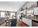Bright kitchen featuring white cabinets, an island with bar stools, and an adjacent dining area at 6431 Meadowpond Way, Indianapolis, IN 46235