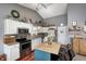Functional kitchen boasts stainless steel appliances, ample storage, and island with barstool seating at 6431 Meadowpond Way, Indianapolis, IN 46235