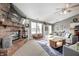 Open-concept living room boasts fireplace, comfortable seating, and access to the kitchen and dining areas at 6431 Meadowpond Way, Indianapolis, IN 46235