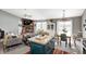 Open floor plan with a living room fireplace, dining area, and kitchen island at 6431 Meadowpond Way, Indianapolis, IN 46235