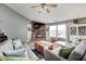 Cozy living room features a brick fireplace, plush seating, and plenty of natural light at 6431 Meadowpond Way, Indianapolis, IN 46235