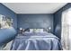 Inviting main bedroom with blue walls, decorative flower wall art, and plush bedding at 6431 Meadowpond Way, Indianapolis, IN 46235