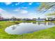 Scenic pond view within a residential community, showcasing a tranquil natural setting and blue skies at 6431 Meadowpond Way, Indianapolis, IN 46235