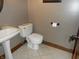 A half bathroom featuring a toilet, sink, and stylish decor at 6712 Forrest Commons Blvd, Indianapolis, IN 46227