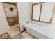 Spa-like bathroom with a soaking tub, walk-in shower with tile surround, and window for natural light at 6712 Forrest Commons Blvd, Indianapolis, IN 46227