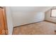 Bedroom featuring neutral carpeting, baseboard trim, and a window for natural light at 6712 Forrest Commons Blvd, Indianapolis, IN 46227