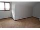 Bright bedroom features neutral walls, plush carpet, and a window with plenty of natural light at 6712 Forrest Commons Blvd, Indianapolis, IN 46227